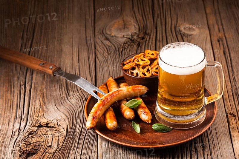Beer mug with sausage snacks wooden board