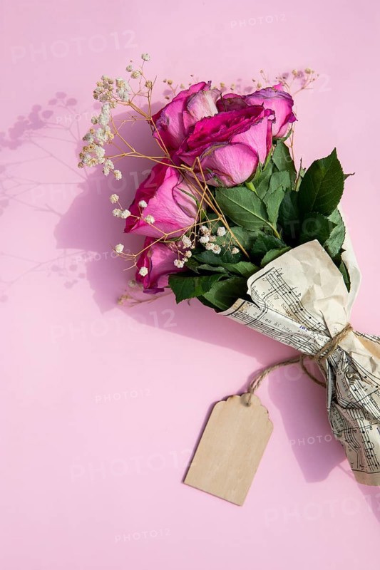 Bouquet roses wrapped music sheet