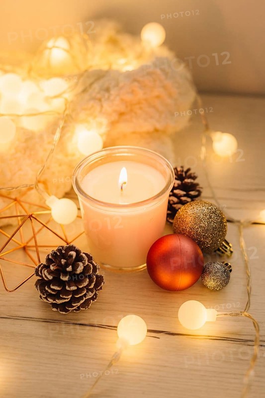 Burning candle with scarf wooden table