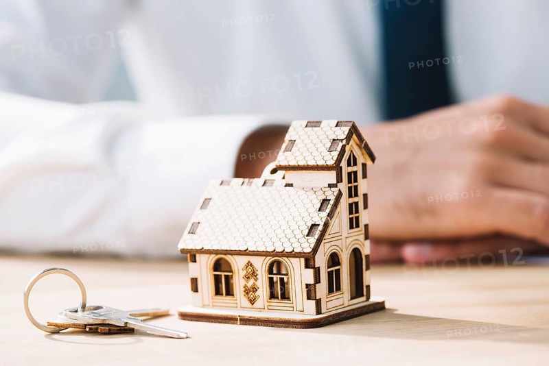 Close up house keys near real estate agent
