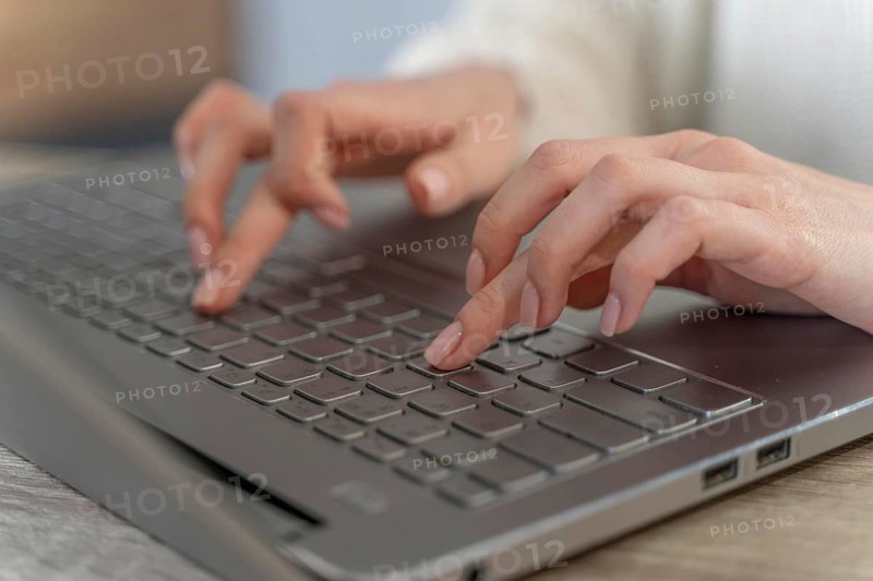 Close up woman typing laptop