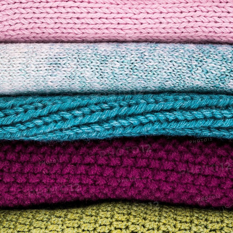 Crocheted colorful wool clothes stacked