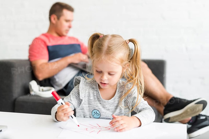 Cute girl drawing sketch with marker home