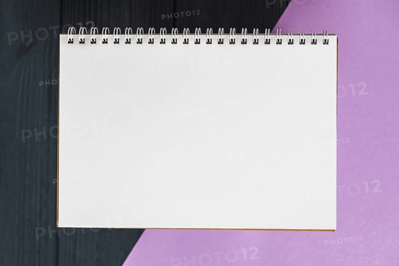 Elevated view spiral notepad colorful background