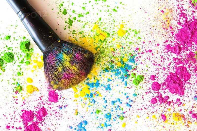Face powder with makeup brush white backdrop