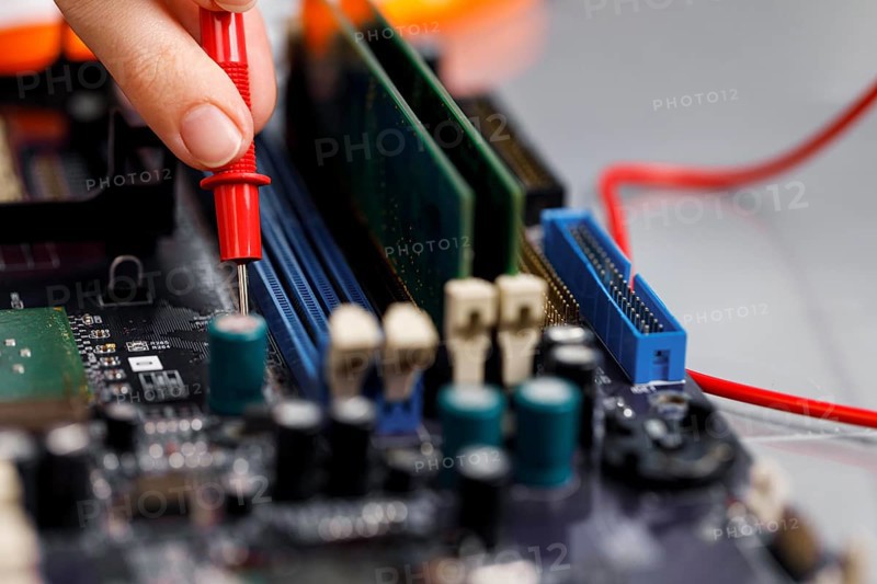 Female technician with computer motherboard