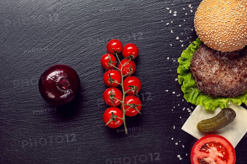 Flat lay burger ingredients slate background