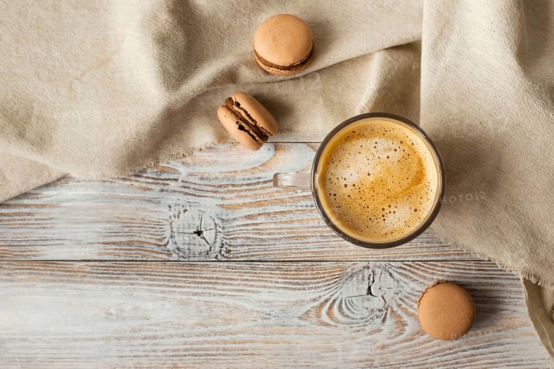 Flat lay cup coffee macarons
