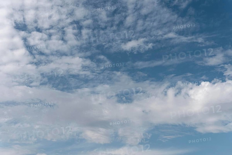 Gradient blue sky with white clouds