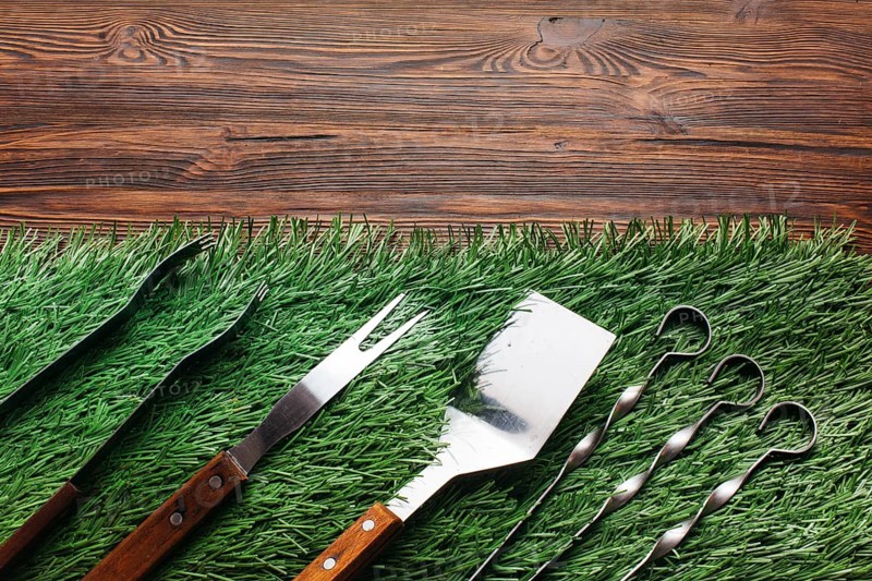 High angle view barbecue utensil set green mat wooden table