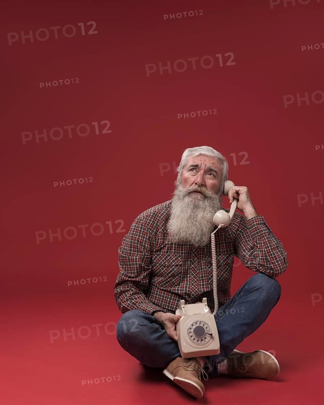 Old man holding telephone