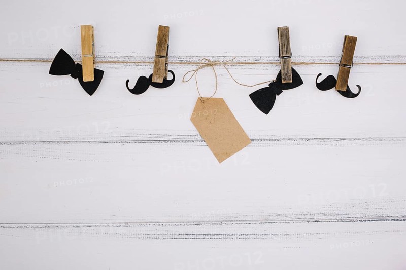 Ornament paper bow tie near mustache tag thread