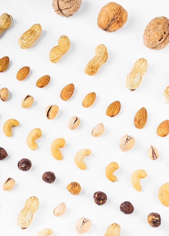 Overhead view walnuts peanuts almonds pistachios hazelnut cashew nuts white background