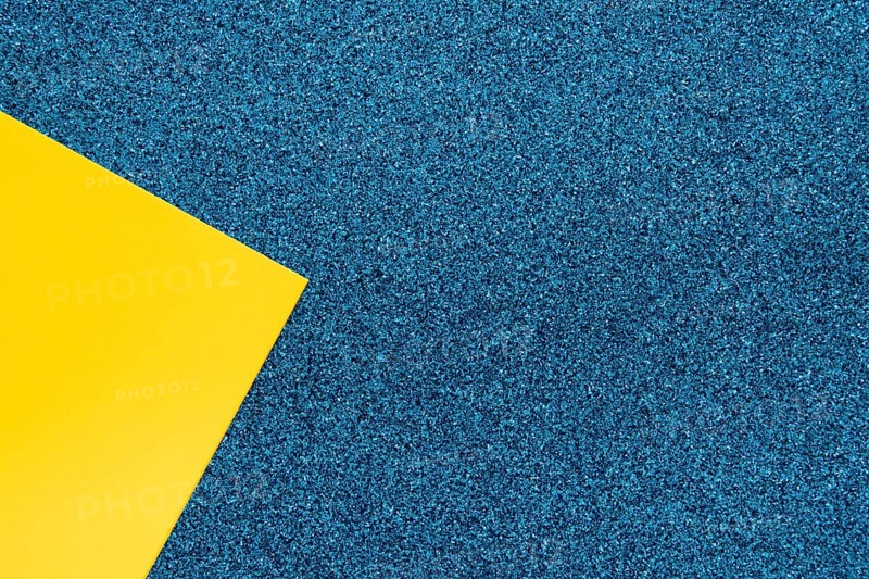 Overhead view yellow cardboard paper blue surface