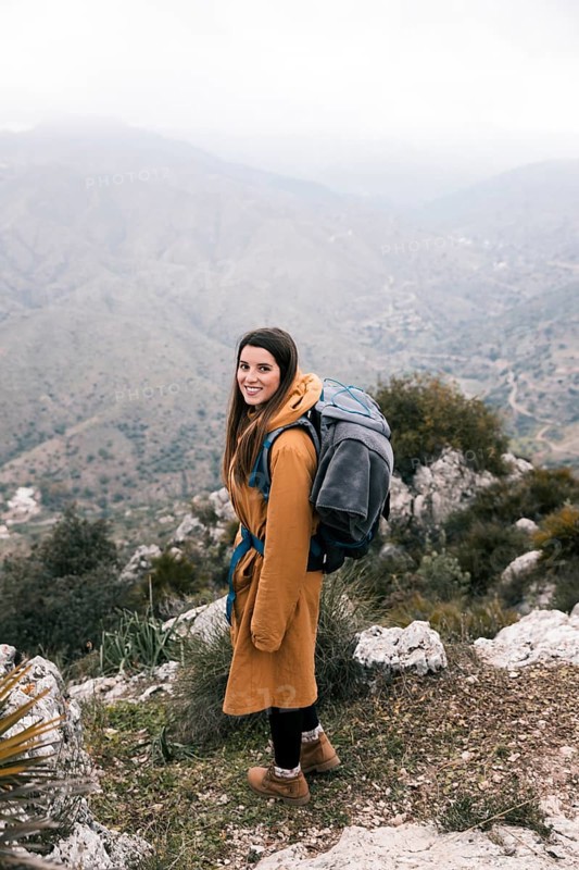 Side view female hiker with her backpack hiking mountains