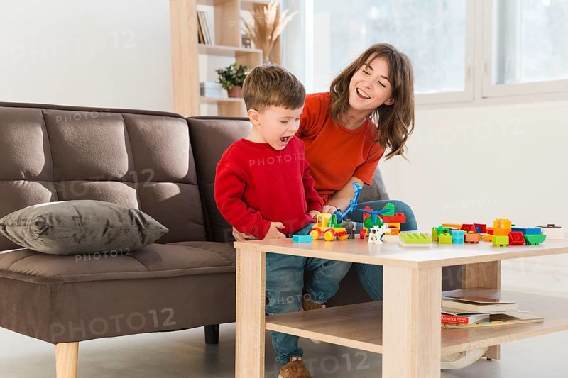 Smiley mother watching son playing