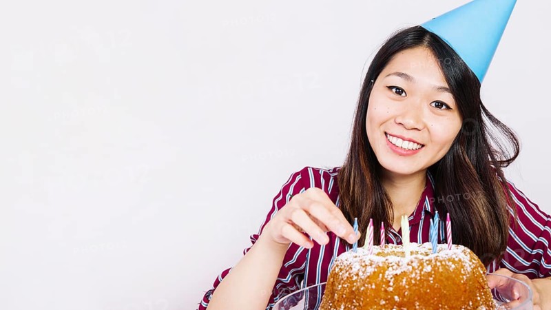 Smiling birthday girl with tasty cake