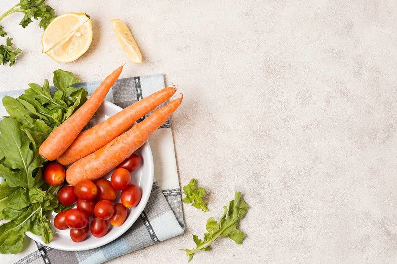 Top view carrots tomatoes plate