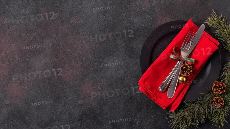 Top view christmas table arrangement with pine cones cutlery