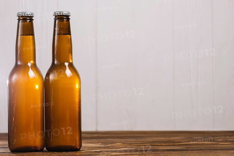 Two beer bottles wooden surface