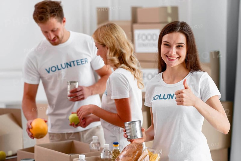 Volunteers helping with food donations giving thumbs up