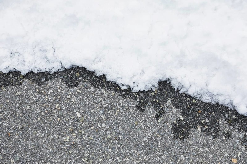 Wet asphalt near snow