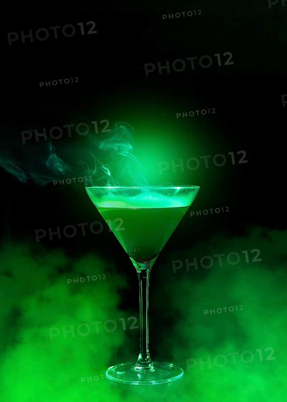 Wineglass with liquor green smoke