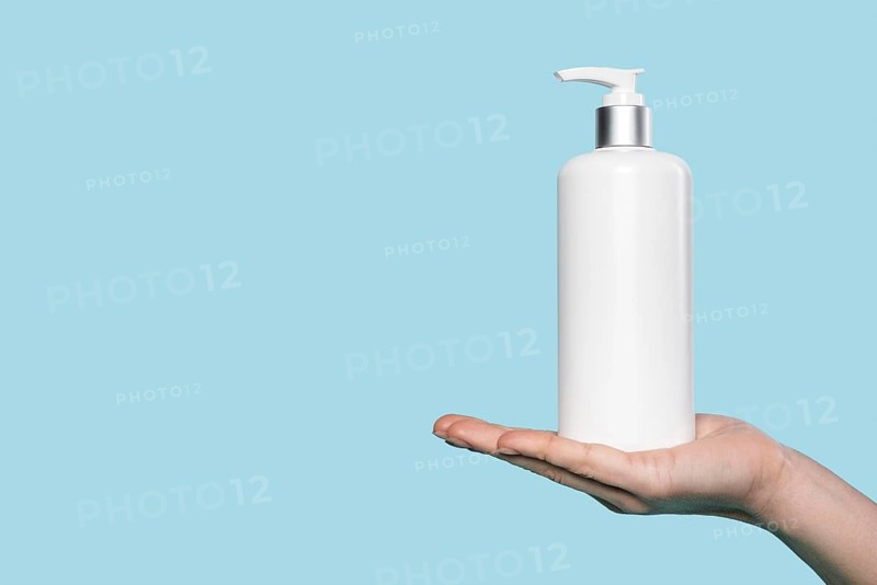 Woman holding liquid soap bottle