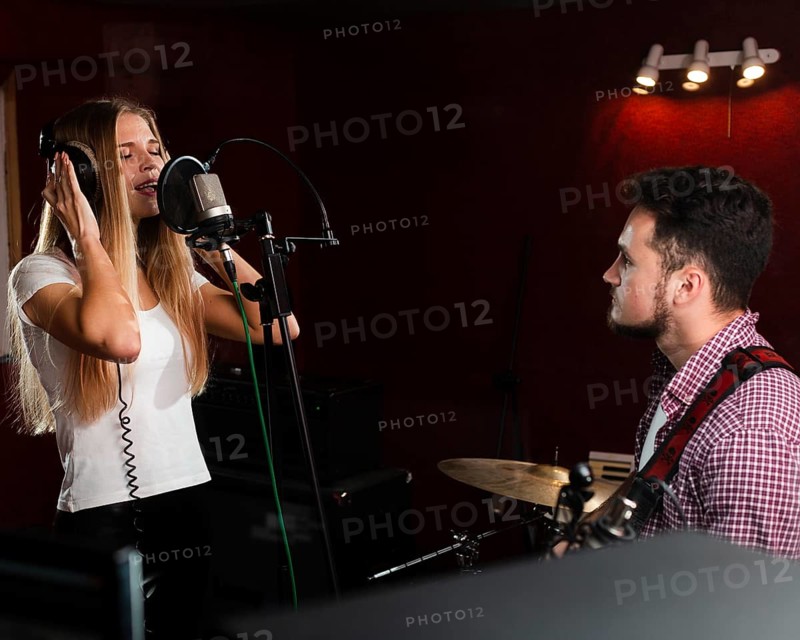 Woman singing microphone guy playing guitar