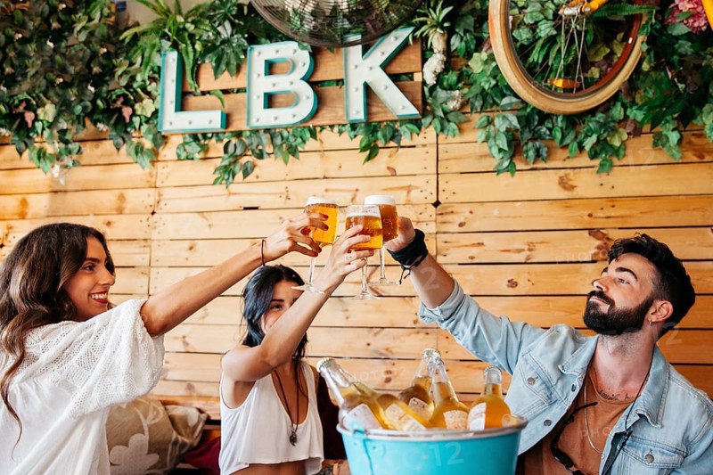 Young friends toasting with beer