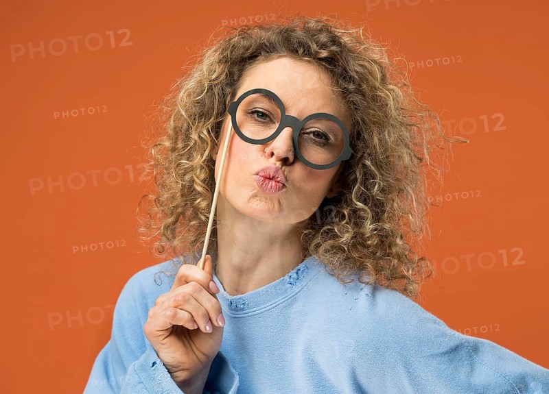 Young woman having fun with fake glasses