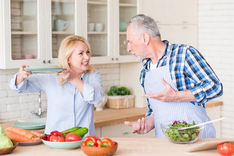Angry senior couple fighting with each other kitchen