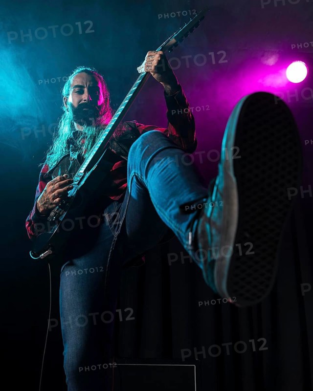 Artist playing guitar low view