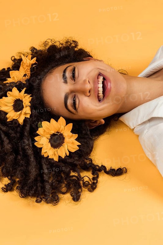 Attractive cheerful woman with flowers hair