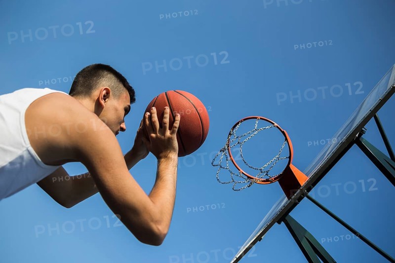 Basketball player throwing ball into net
