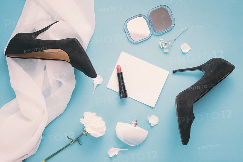 Blank paper with woman shoes lipstick table