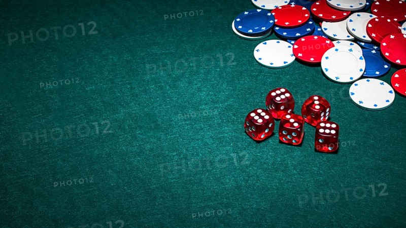 Bright red dices casino chips green poker background