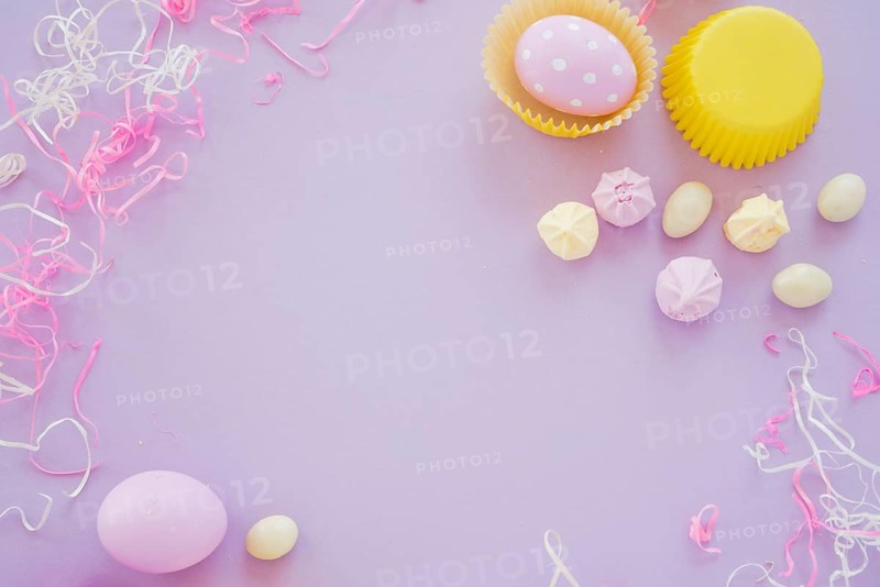 Easter eggs with small sweets purple table