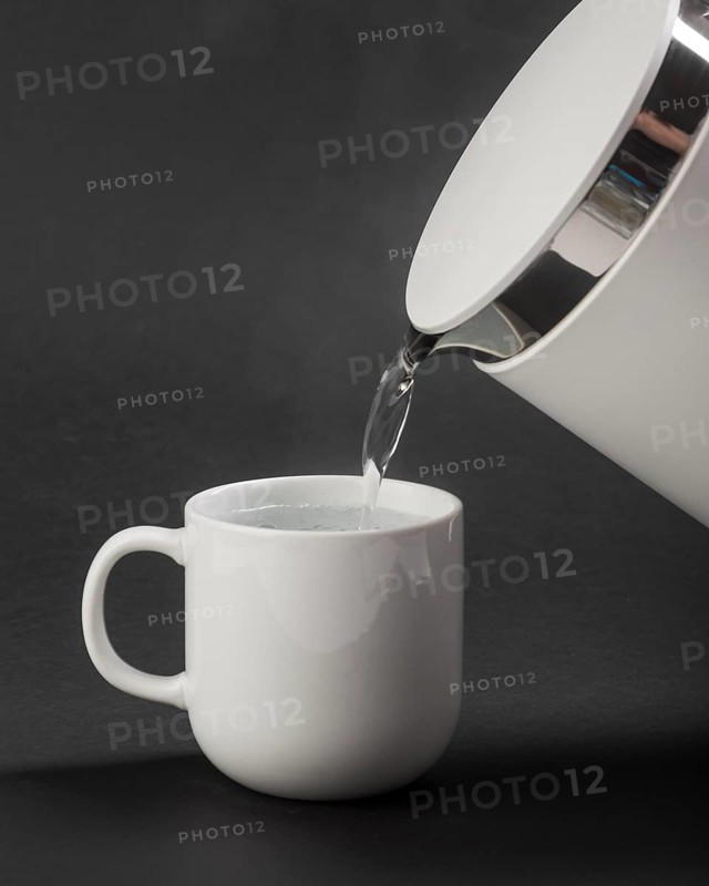 Electric kettle pouring water cup