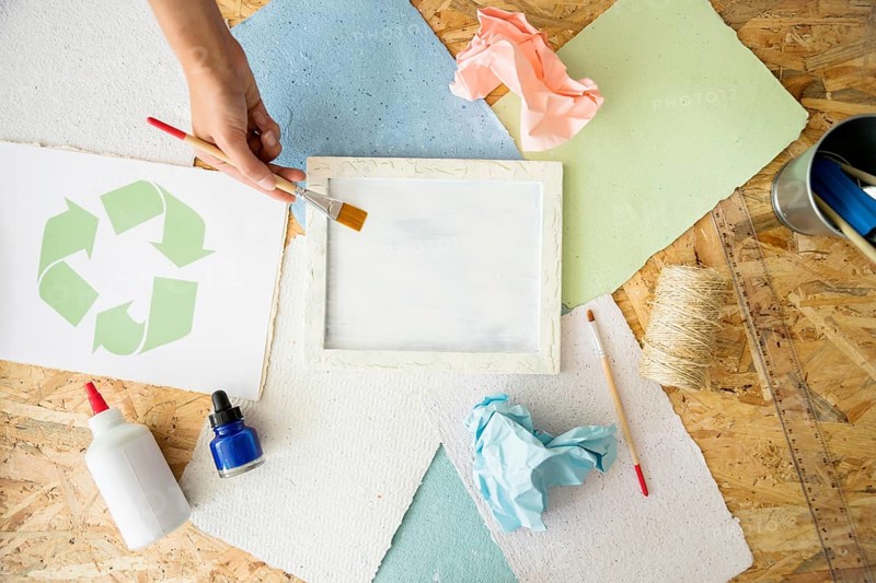 Elevated view woman s hand painting white paint mold