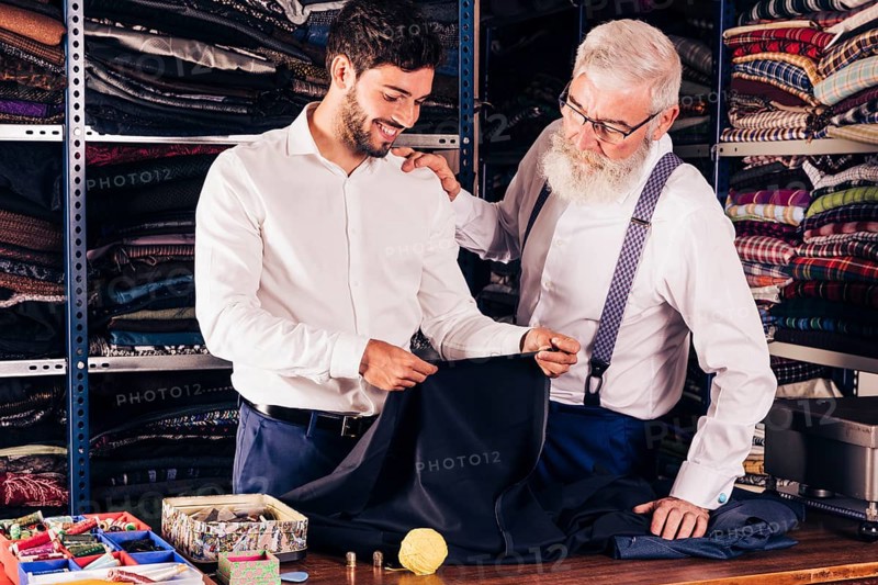 Fashion designer customer looking fabric his shop
