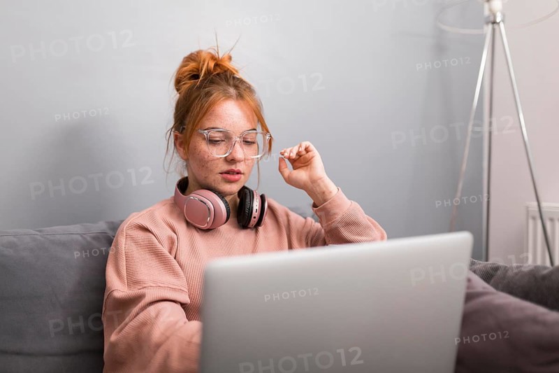 Female teacher using laptop from home hold online class
