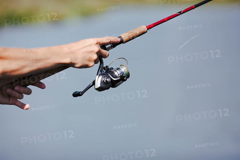 Fisherman s hand fishing blurred background