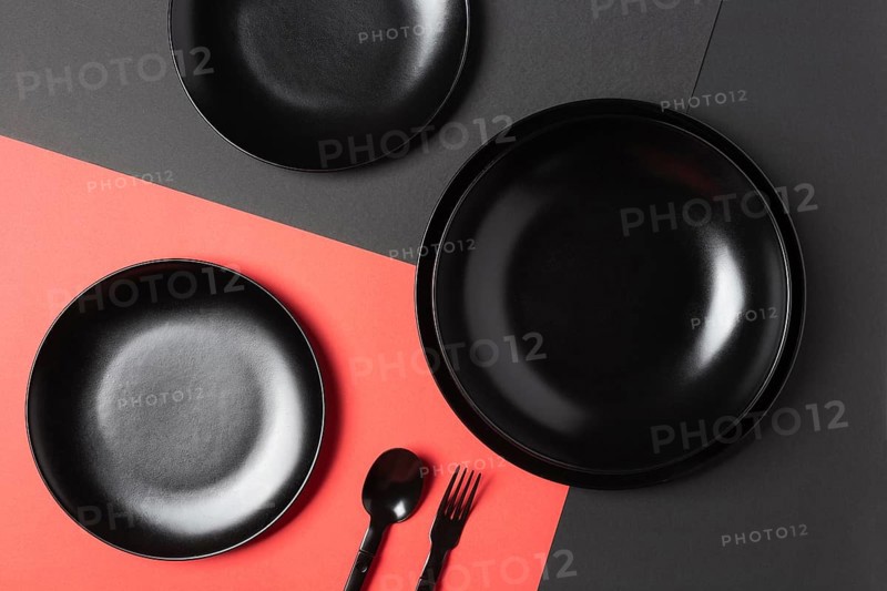 Flat lay black plates composition