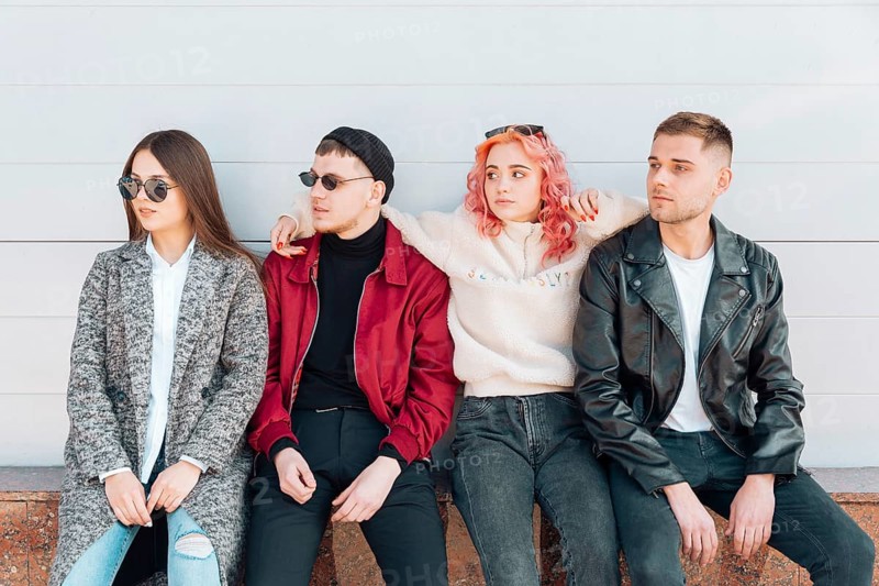 Friends sitting bench looking same direction