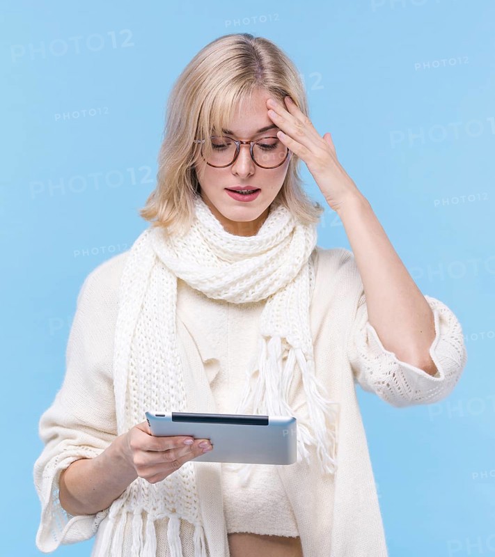 Front view blonde woman holding tablet