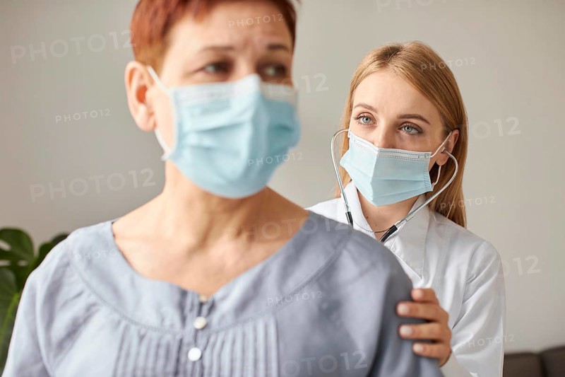 Front view elder patient with medical mask covid recovery center female doctor with stethoscope
