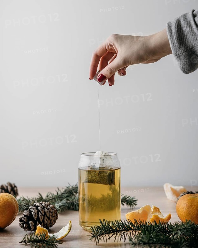 Front view person taking tea bag out jar