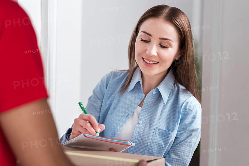 Front view woman signing forms delivery