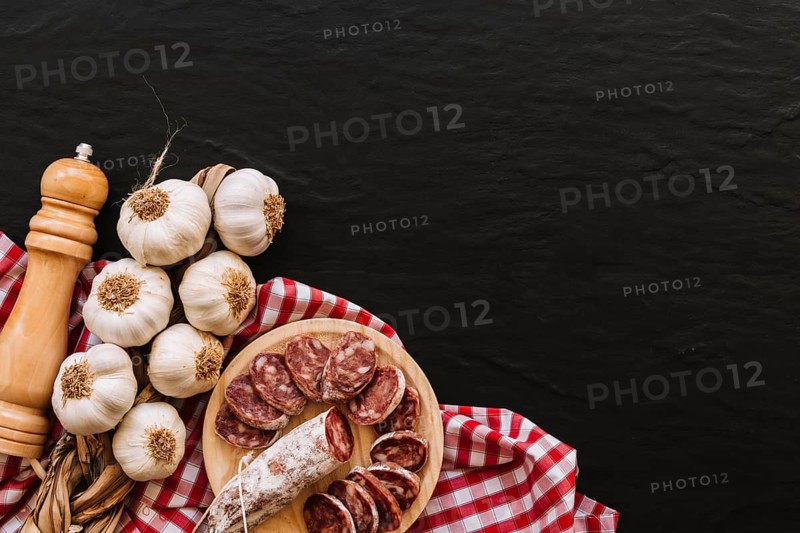 Garlic sausages near spices napkin